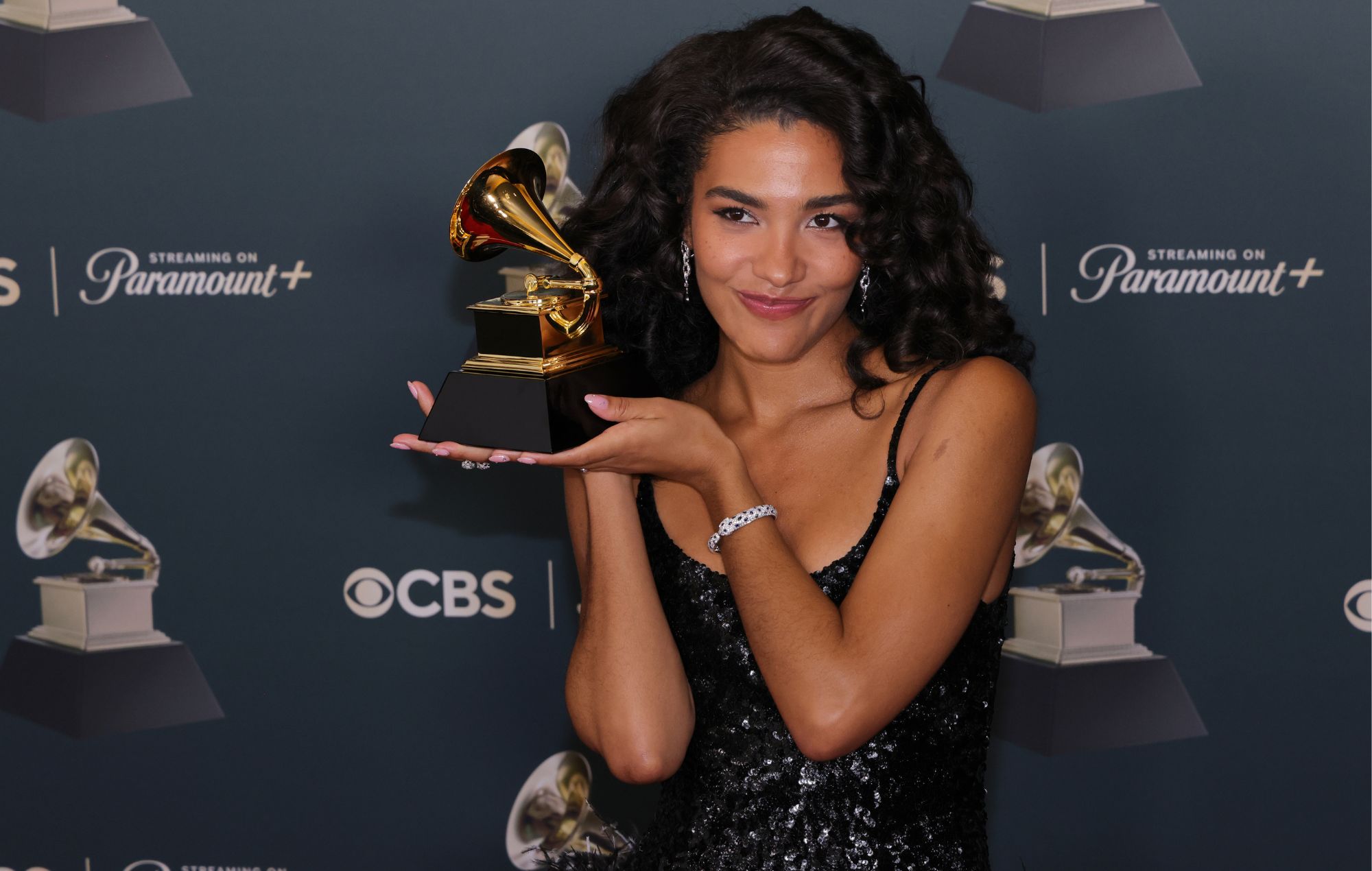 Olivia Dean holds her trophy at 2026 Grammy Awards. CREDIT: Julian Hamilton/WireImage/Getty