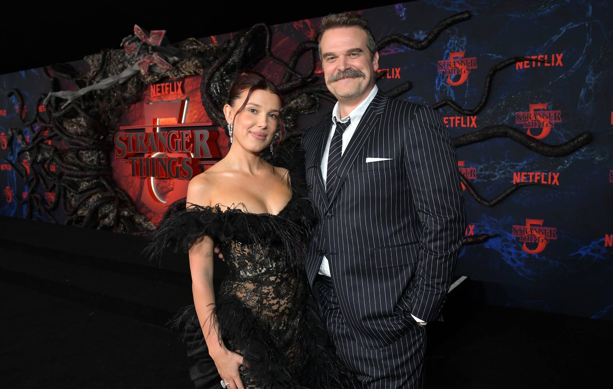 Millie Bobby Brown and David Harbour at TCL Chinese 6 Theatres on November 06, 2025 in Hollywood, California. (Photo by Charley Gallay/Getty Images for Netflix)