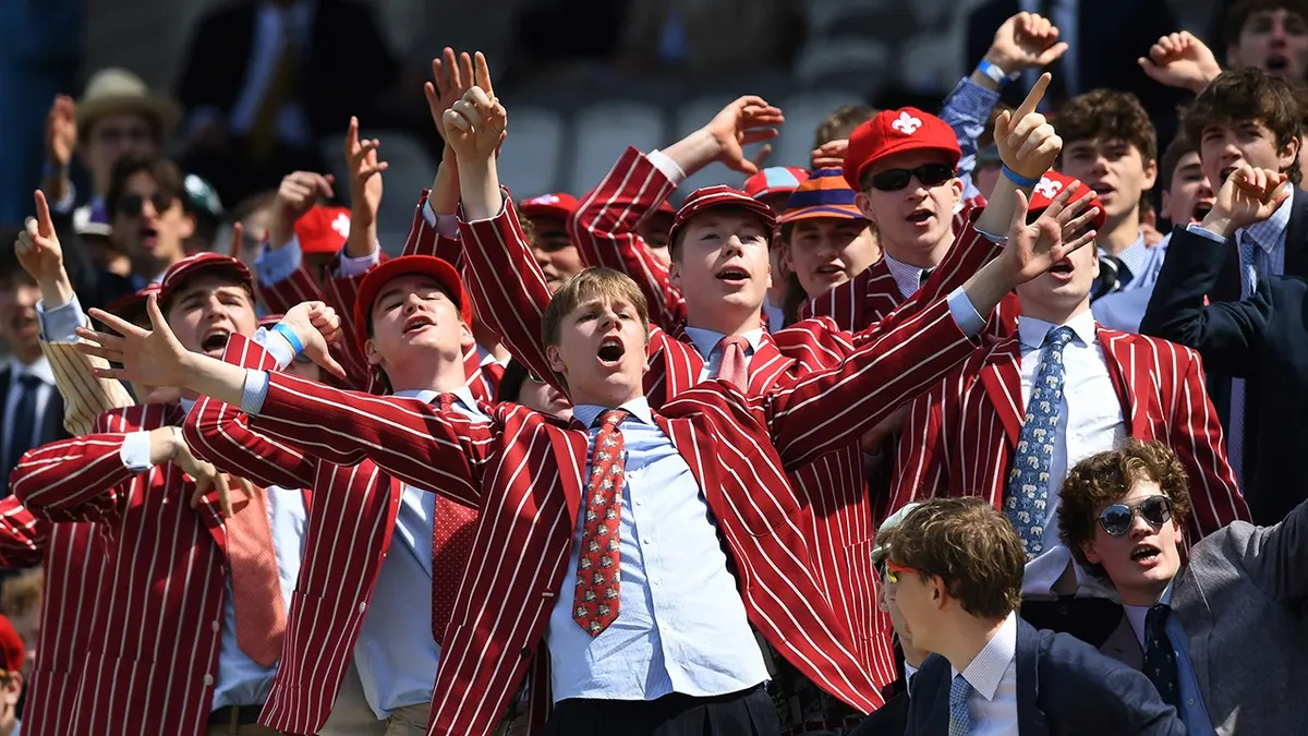 Students from Eton College react in the Mound Stand at Lord