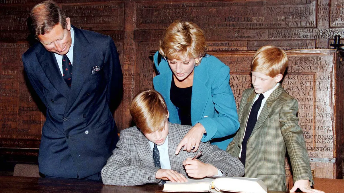 Prince William signs in at Eton College while his parents and Prince Harry watch.