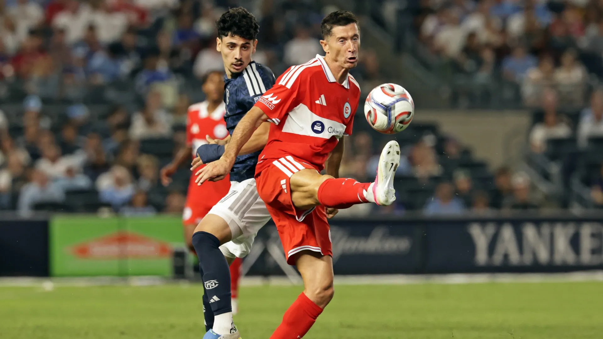 Robert Lewandowski #9 of the Chicago Fire FC controls the ball in front of Arnau Farnós #87 of the NYCFC.