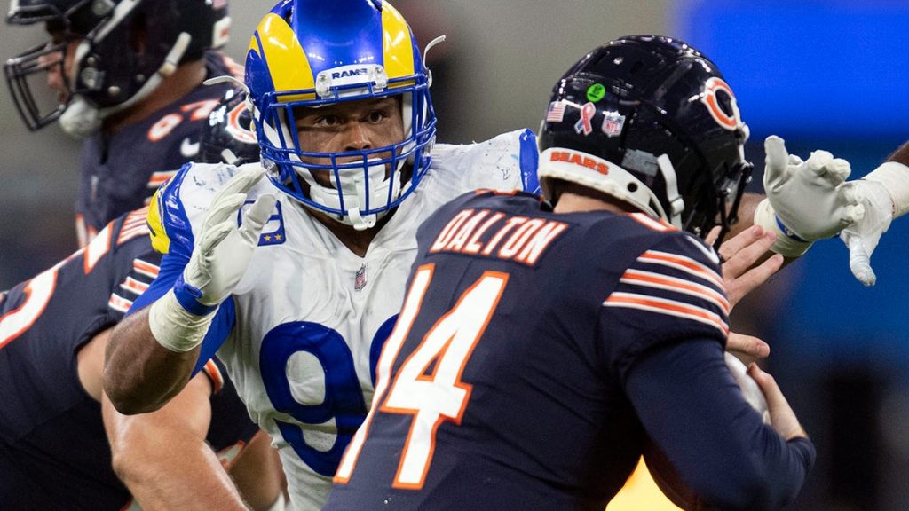 FILE- In this Sunday, Sept. 12, 2021, file photo, Los Angeles Rams defensive end Aaron Donald (99) tackles Chicago Bears quarterback Andy Dalton (14) during an NFL football game in Inglewood, Calif. As Donald, now 30, closes in on the franchise