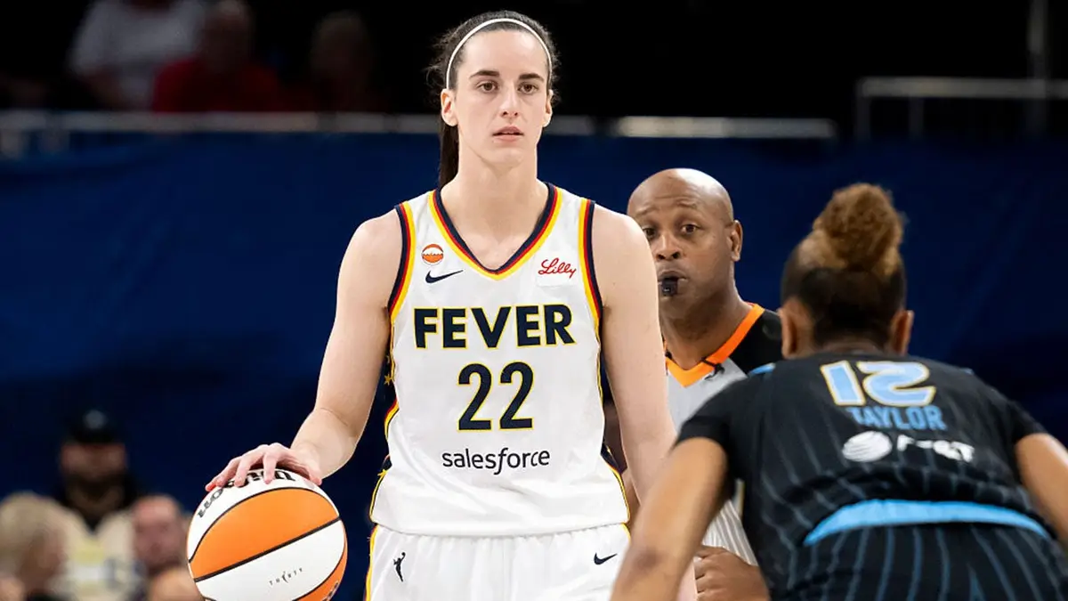 Caitlin Clark dribbles the ball against Sydney Taylor during a WNBA game.