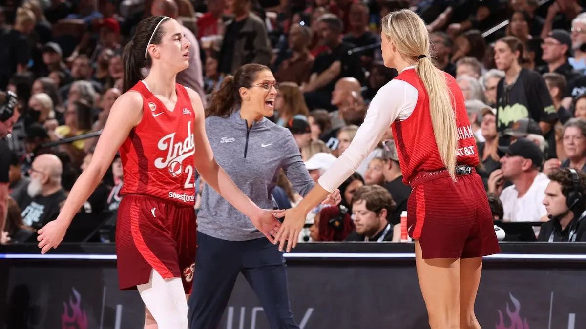 Caitlin Clark #22 and Sophie Cunningham #8 high five during an Indiana Fever game.