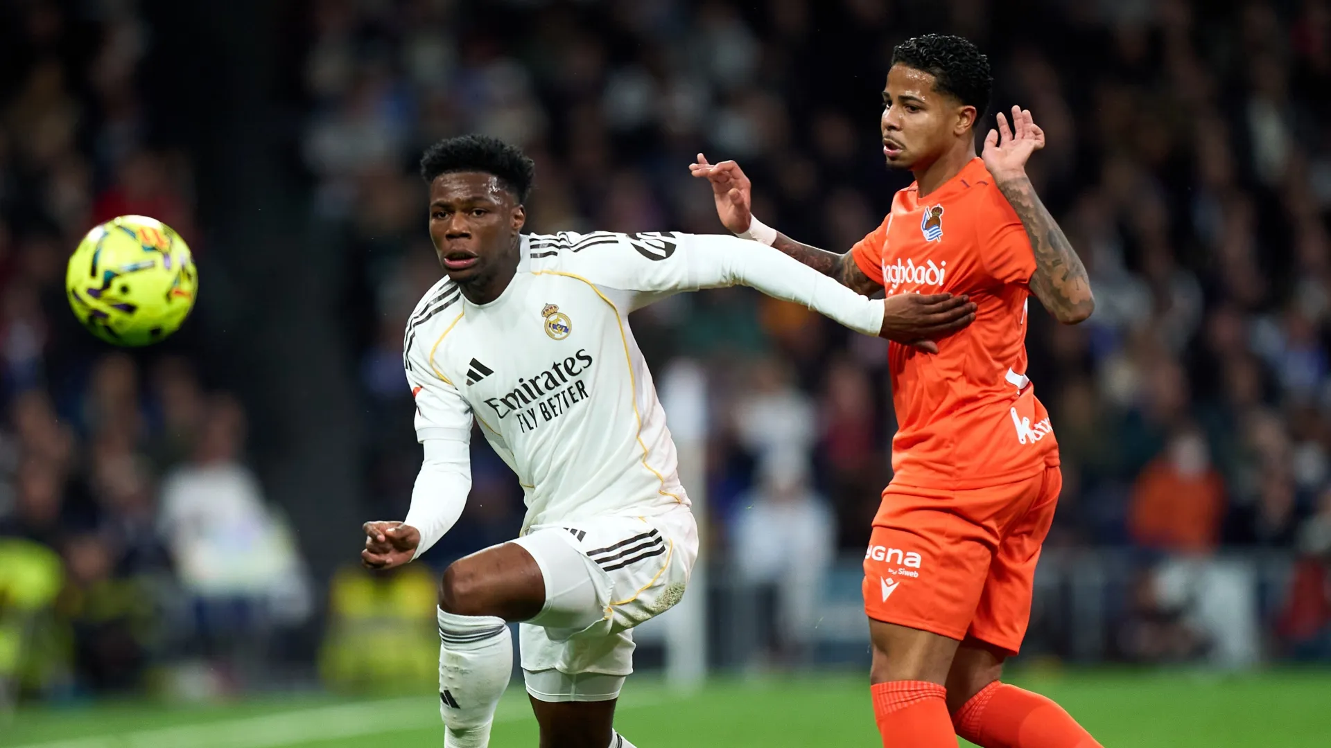 Aurelien Tchouameni of Real Madrid is challenged by Wesley of Real Sociedad.