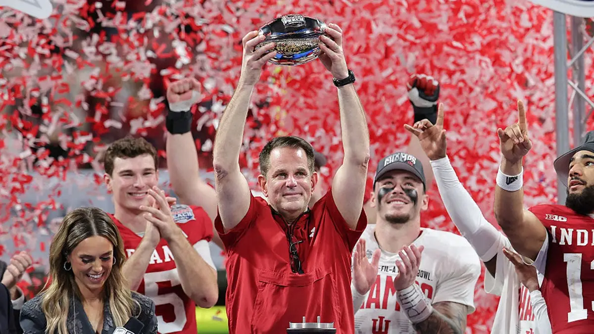 Curt Cignetti hoists the George P. Crumbley Trophy after Indiana