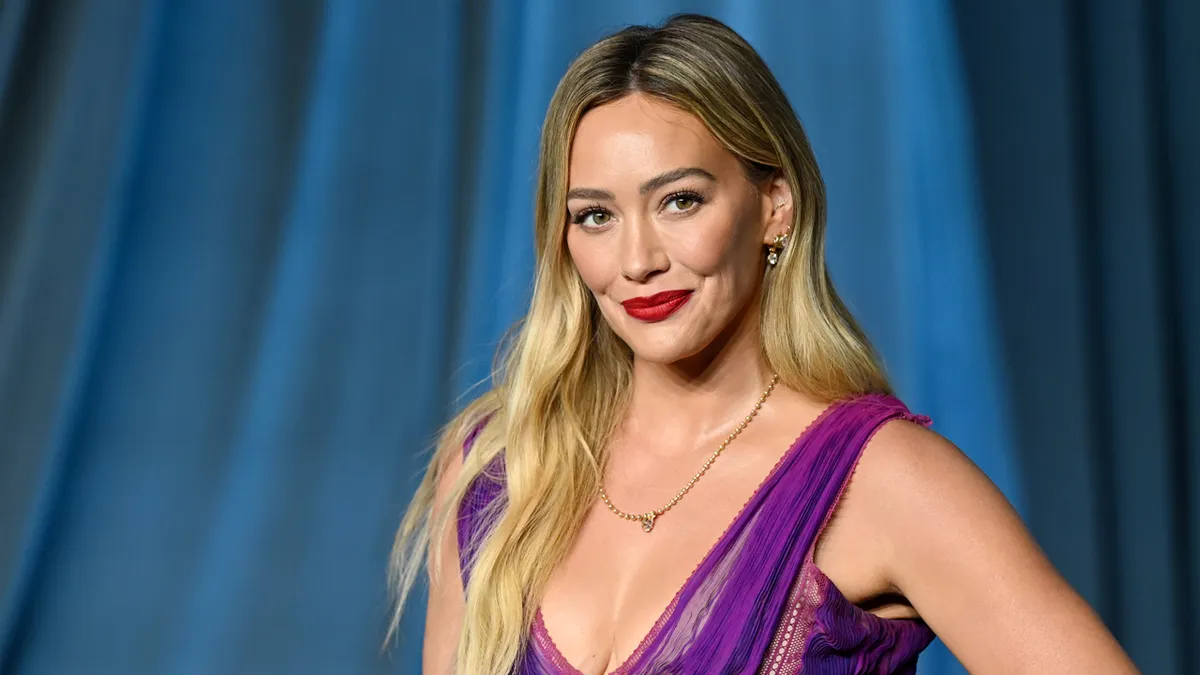 Hilary Duff posing on a red carpet at the Academy Museum Gala.