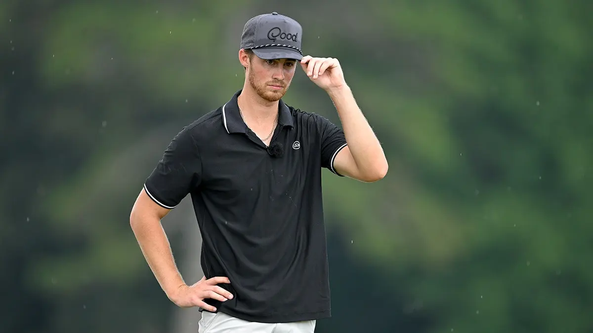Garrett Clark adjusts his hat on the 15th green at East Lake Golf Club.