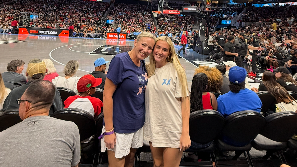 Kasey and Annie Thomason courtside in XX-XY t-shirts for Fever vs Dream 8/16/26