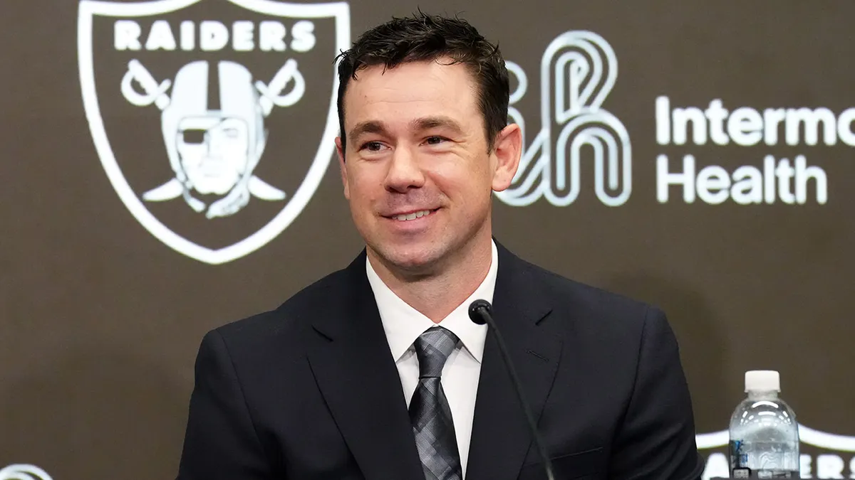 Klint Kubiak speaks at a press conference