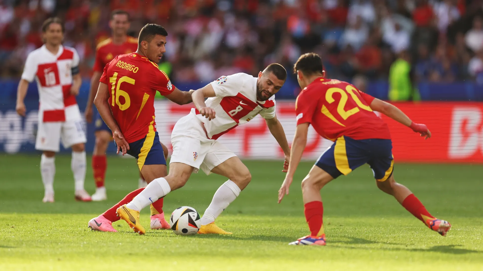 Mateo Kovacic of Croatia battles for possession with Rodri and Pedri of Spain.