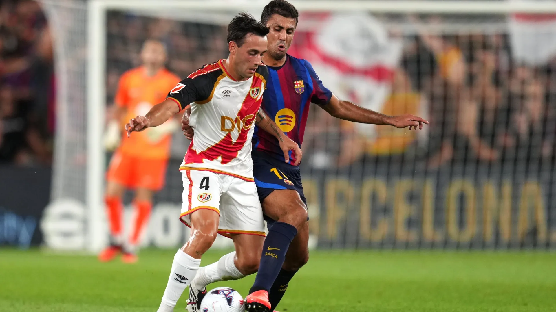 Pedro Diaz of Rayo Vallecano is challenged by Rodri of Barcelona.