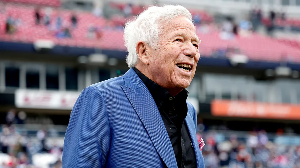 Patriots owner Robert Kraft smiles on the field before a game at Nissan Stadium.