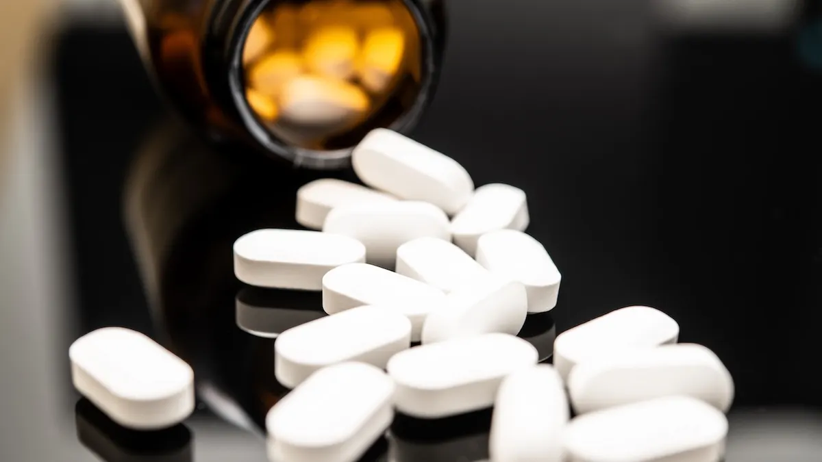Pills spilling out of prescription bottle