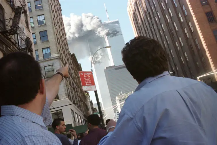 Pedestrians react to the World Trade Center collapse September 11,
2001. Two commercial airplanes crashed into the World Trade Center
earlier. REUTERS/Richard Cohen
AC