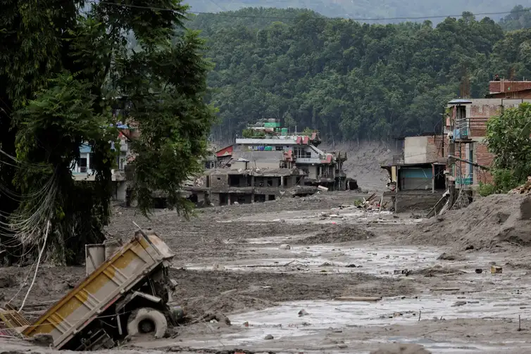Mud covers houses and a road following a flash flood at Trishuli in Nuwakot district, Nepal, August 26, 2026. REUTERS/Navesh Chitrakar