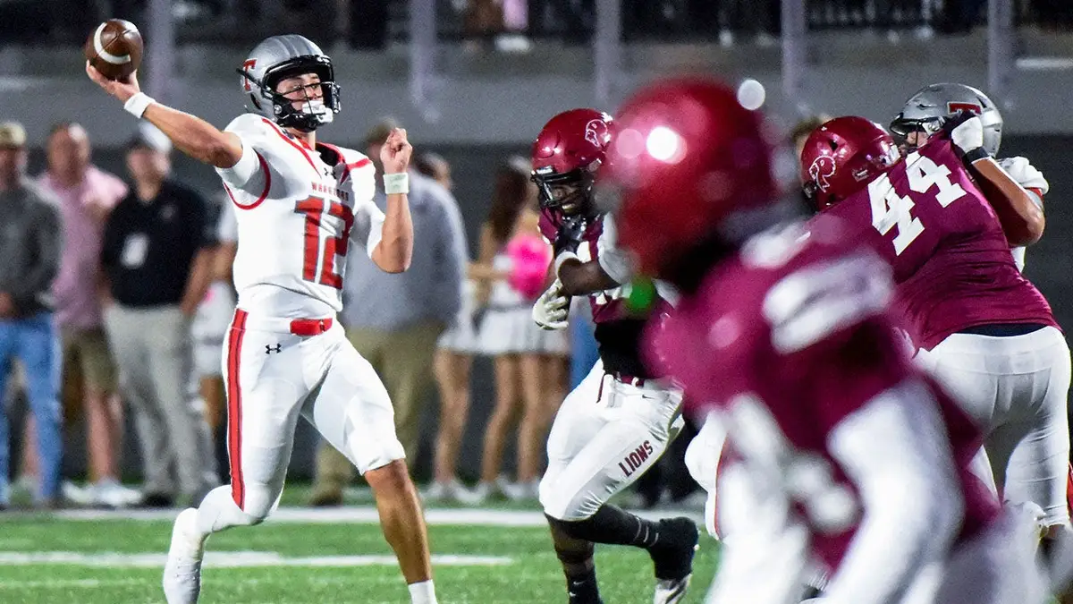 Trent Seaborn, Thompson quarterback, throws a touchdown pass during a game.