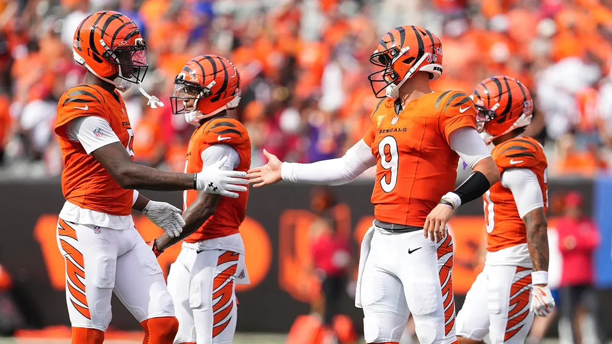 Joe Burrow celebrates with Tee Higgins after a Bengals win in Cincinnati.
