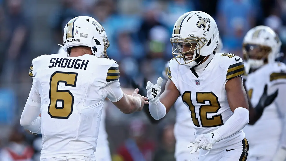 Tyler Shough #6 and Chris Olave #12 of the New Orleans Saints celebrate a touchdown.