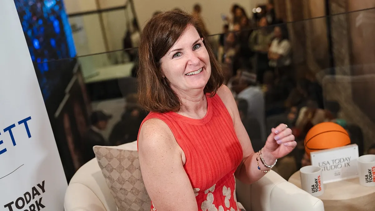 Nancy Armour smiles during an interview at a WNBA Draft watch party.