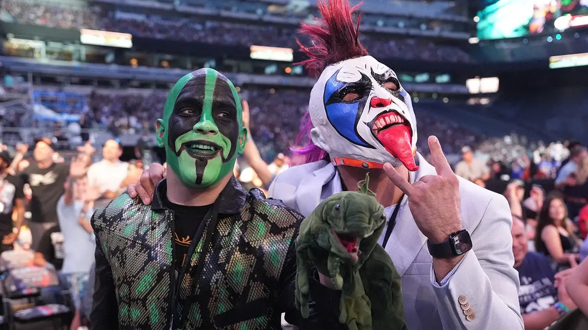 Mr. Iguana and Psycho Clown sit in the audience at MetLife Stadium.