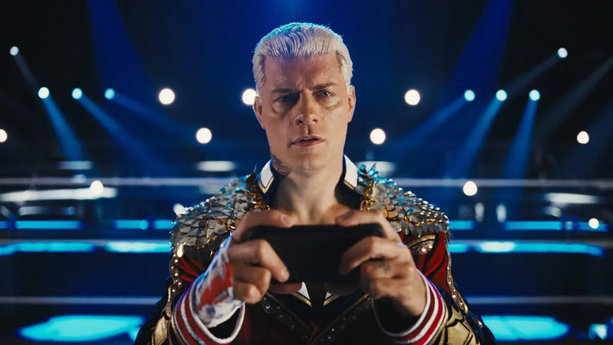 Cody Rhodes holds his phone