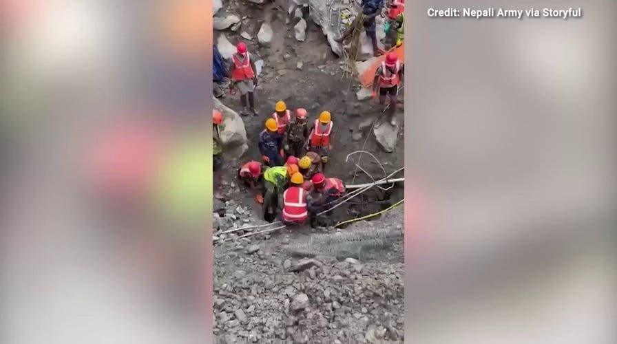 Rescue crews in Nepal save two men trapped in tunnels for nine days following floods