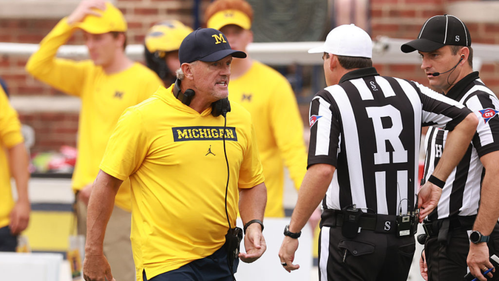 Kyle Whittingham talks with referees during Michigan Wolverines game against Oklahoma Sooners.