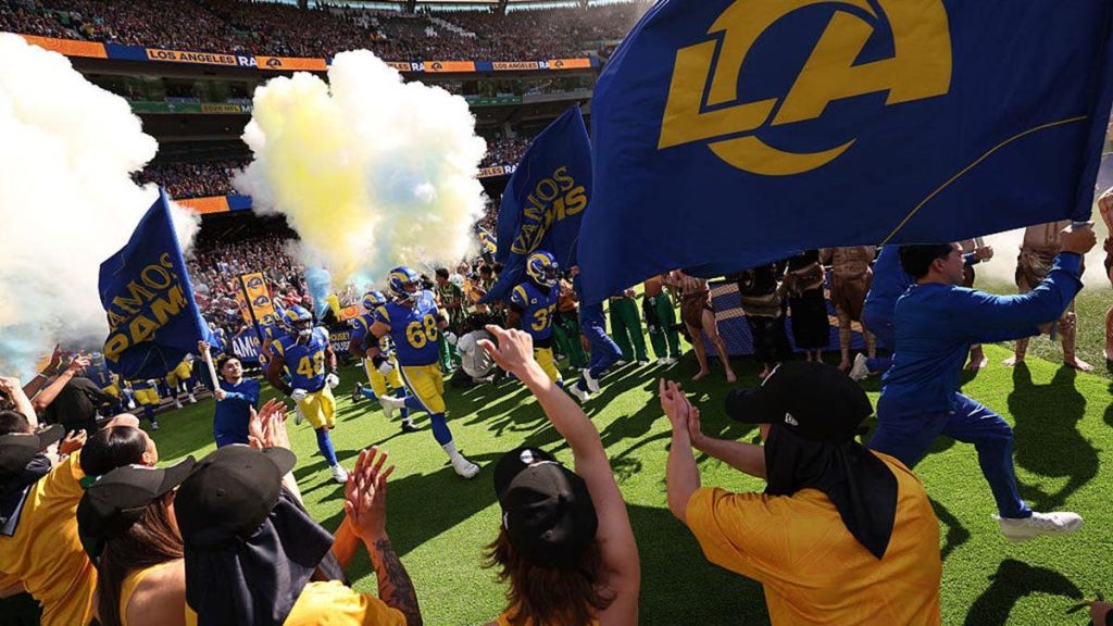 Los Angeles Rams members run onto the field before an NFL game in Melbourne, Australia.