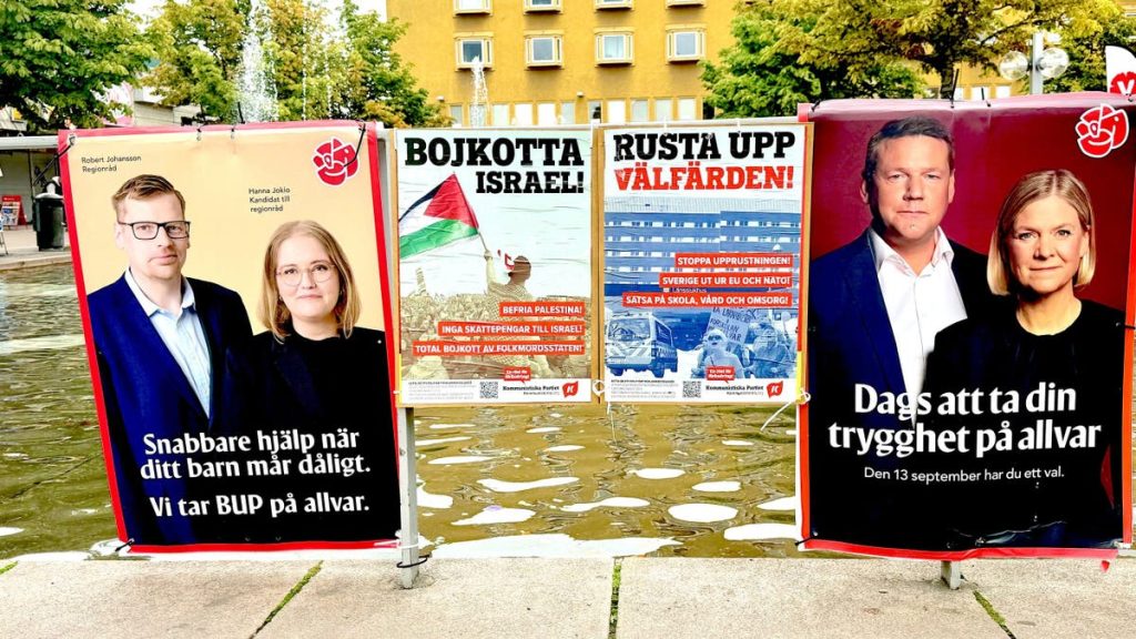 Election campaign posters displayed in a public area in Stockholm, Sweden.