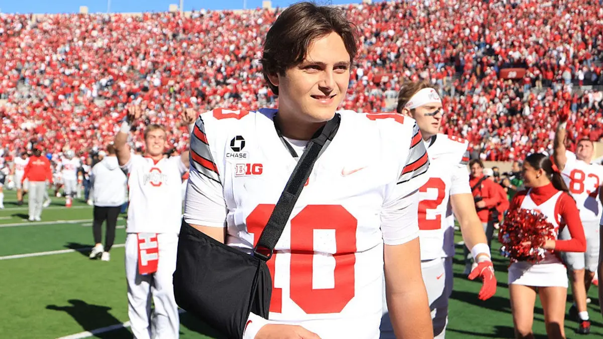 Julian Sayin walks off the field with his arm in a sling.