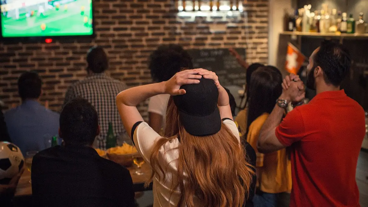 Soccer fans cheer for a German team inside a pub.