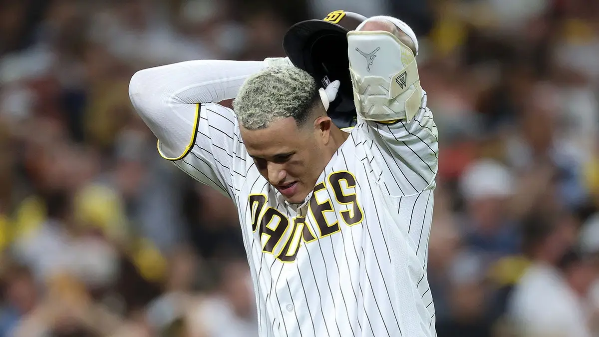Manny Machado reacts after flying out during an MLB playoff game.