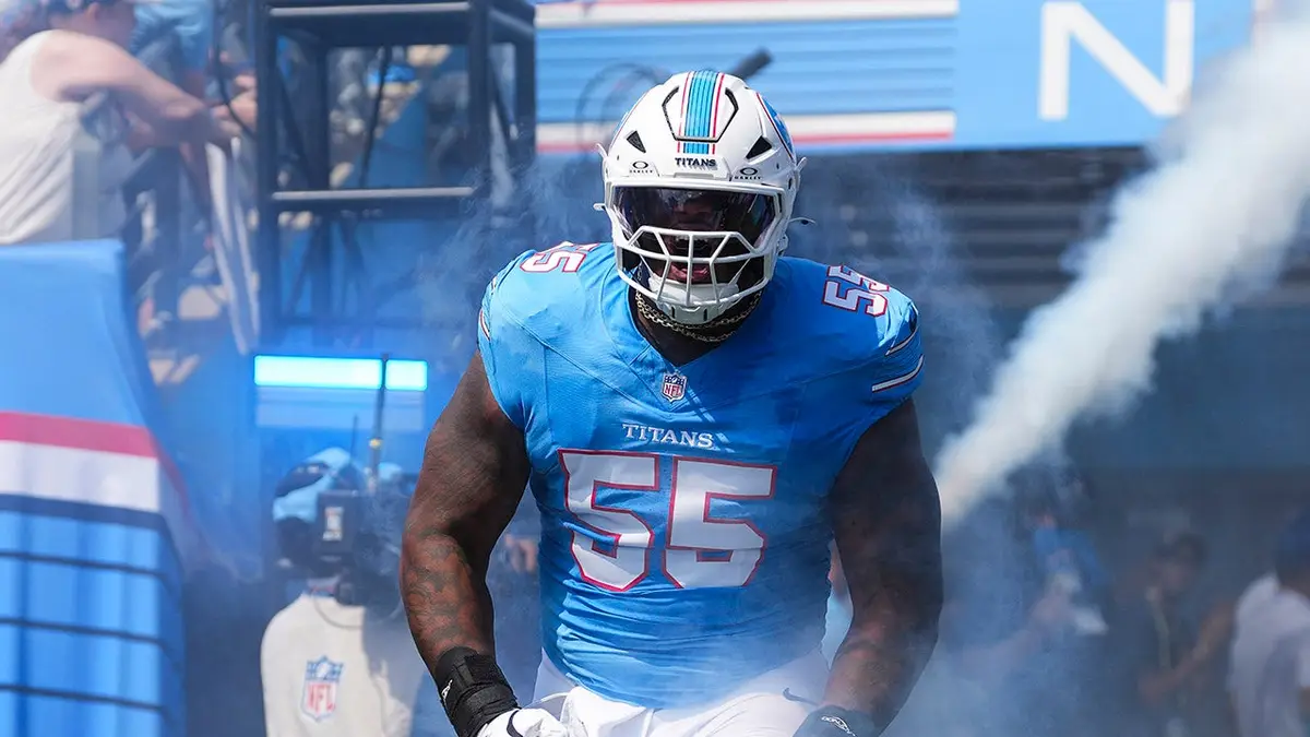 JC Latham #55 runs out before an NFL game at Nissan Stadium.