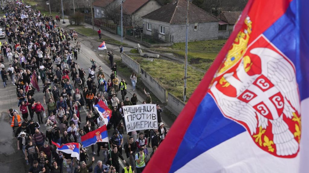 Students walk on the road towards the northern city of Novi Sad, where they will participate in a 24 hour block of three bridges to protest the deaths of 15 people killed in the November collapse of a train station canopy, near the Belgrade suburb of Batajnica, Serbia, Thursday, Jan. 30, 2025. 