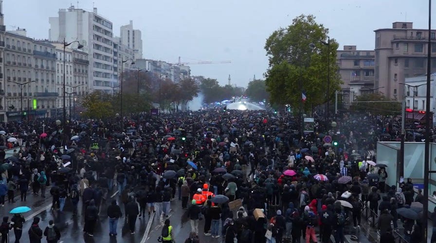 Police in Paris fire water cannons at protesters